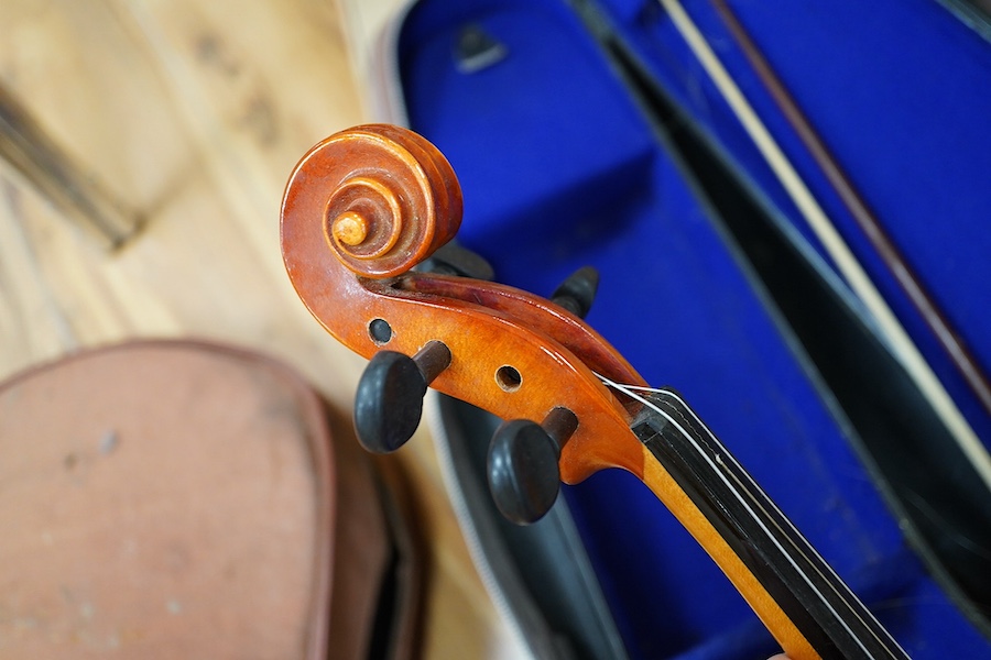 A quantity of violin parts and violins, a ukelele, a double bass scroll, a pinfold metronome, a violin case by Hill, a viola etc. Condition - for restoration